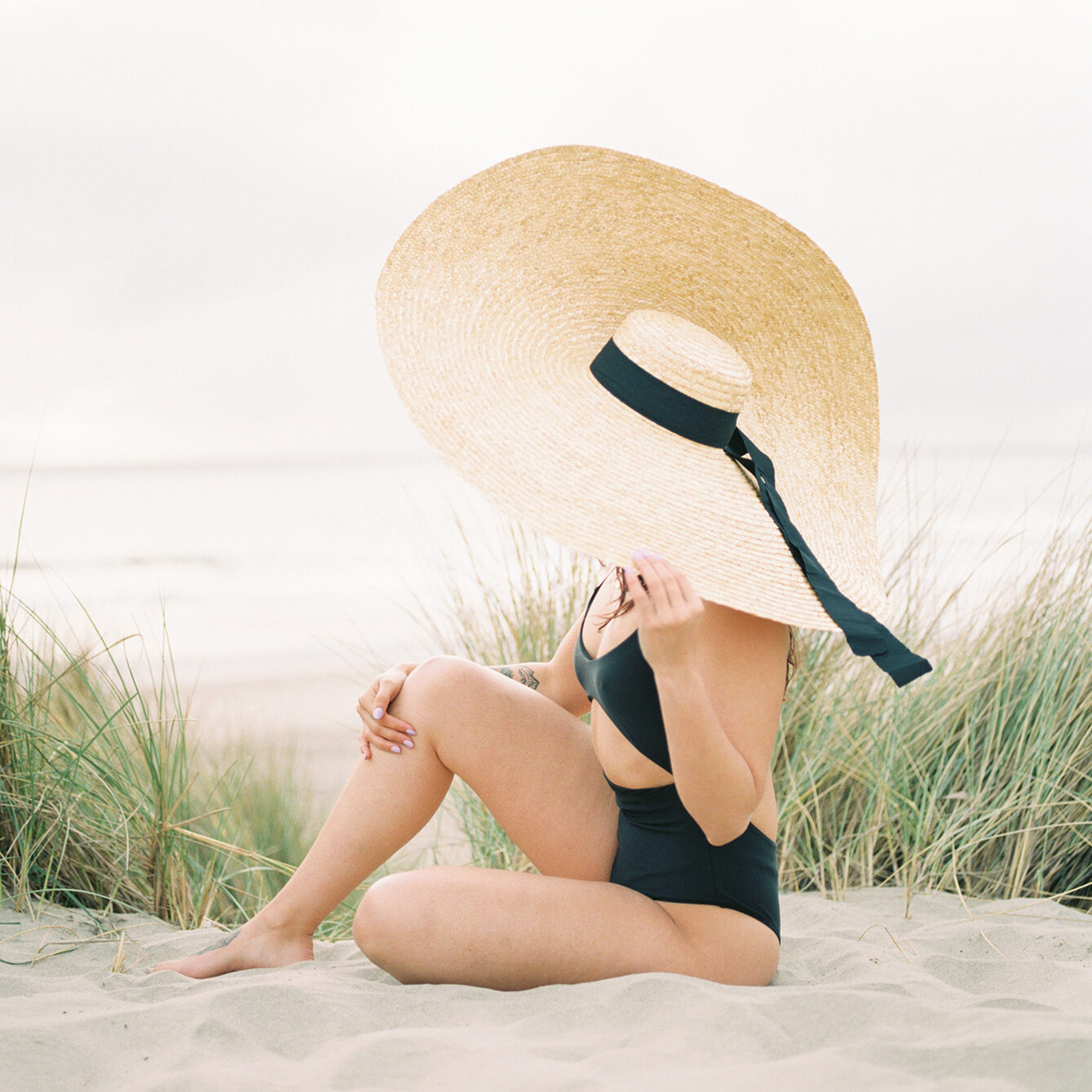 skincare tips for summer - wearing a hat at the beach